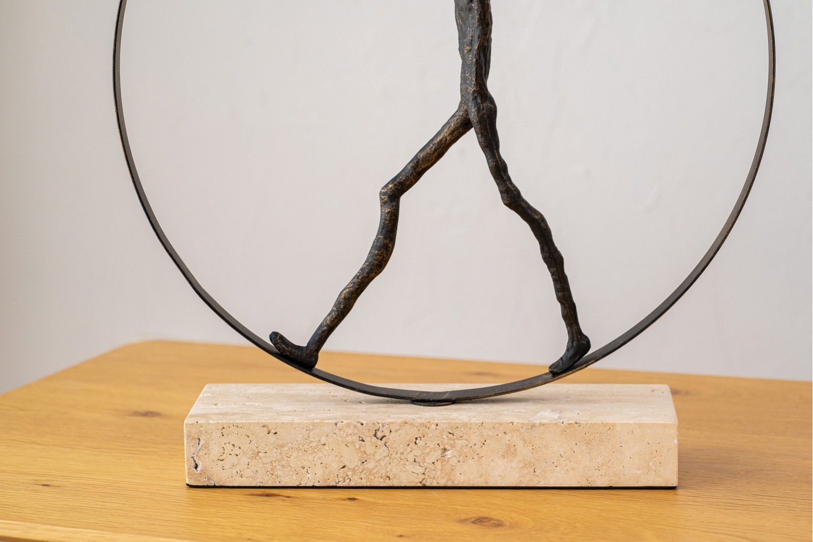 SCULPTURE WALKING IN A CIRCLE. METAL AND MARBLE